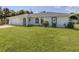 Single-story home with attached garage and well-maintained lawn at 21019 Lawson Ave, Port Charlotte, FL 33952
