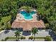 Community clubhouse and kidney-shaped pool from above at 4522 Cancello Grande Ave, Venice, FL 34293