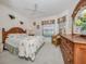 Bright bedroom with a queen bed and wood furniture at 4522 Cancello Grande Ave, Venice, FL 34293