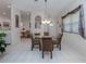 Charming dining area with glass table and four chairs, open to the kitchen at 4522 Cancello Grande Ave, Venice, FL 34293