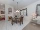 Casual dining area with glass-top table and four chairs at 4522 Cancello Grande Ave, Venice, FL 34293
