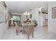 Dining room with glass table, chairs, and kitchen access at 4522 Cancello Grande Ave, Venice, FL 34293