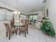 Bright dining room adjacent to living room and kitchen at 4522 Cancello Grande Ave, Venice, FL 34293