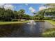 Community entrance with a pond and fountain at 4522 Cancello Grande Ave, Venice, FL 34293