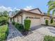 Well-maintained exterior, two-car garage, and attractive landscaping at 4522 Cancello Grande Ave, Venice, FL 34293
