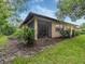 Home exterior showcasing a screened porch and landscaped yard at 4522 Cancello Grande Ave, Venice, FL 34293
