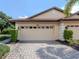 Beige house with two-car garage and paved driveway at 4522 Cancello Grande Ave, Venice, FL 34293