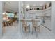 Kitchen features white cabinetry and breakfast bar at 4522 Cancello Grande Ave, Venice, FL 34293