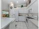 Bright kitchen with white cabinets and a view into the dining area at 4522 Cancello Grande Ave, Venice, FL 34293