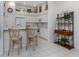 Kitchen features white cabinets, breakfast bar, and convenient shelving at 4522 Cancello Grande Ave, Venice, FL 34293
