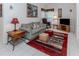 Cozy living room featuring a sofa, TV, and workspace at 4522 Cancello Grande Ave, Venice, FL 34293
