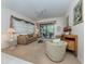 Bright living room with comfy seating and access to a screened patio at 4522 Cancello Grande Ave, Venice, FL 34293