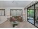 Living room with sofa, glass coffee table, and sliding glass doors at 4522 Cancello Grande Ave, Venice, FL 34293