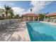 Community pool with adjacent restrooms and seating at 4522 Cancello Grande Ave, Venice, FL 34293