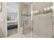 Modern bathroom with a glass-enclosed shower, neutral tiles, and a built-in bench at 12000 Tapestry Ln, Venice, FL 34293