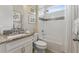 Bathroom with a shower and a vanity with granite counter and a white sink at 12000 Tapestry Ln, Venice, FL 34293