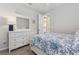 Inviting bedroom with white furniture, a floral comforter, and natural light at 12000 Tapestry Ln, Venice, FL 34293