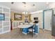 Charming kitchen with a breakfast bar, featuring white cabinets and stainless steel appliances at 12000 Tapestry Ln, Venice, FL 34293