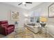 Cozy living room featuring a ceiling fan, comfortable seating, and stylish glass tables at 12000 Tapestry Ln, Venice, FL 34293