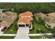 Two-story house with tile roof, two-car garage, and landscaped yard at 12232 Stuart Dr, Venice, FL 34293