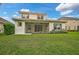 Two-story house with a screened-in porch and spacious grassy backyard at 12232 Stuart Dr, Venice, FL 34293