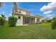 Large backyard with green grass and home view at 12232 Stuart Dr, Venice, FL 34293