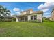 Two-story house with a screened lanai and lush landscaping at 12232 Stuart Dr, Venice, FL 34293