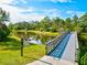 Wooden bridge leading to Lookout Point Island, offering serene views at 12232 Stuart Dr, Venice, FL 34293