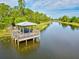 Lakeside gazebo with picnic tables, offering a peaceful community space at 12232 Stuart Dr, Venice, FL 34293