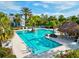 Relaxing community pool with a swim-up bar and thatch-roof hut at 12232 Stuart Dr, Venice, FL 34293