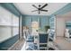 Elegant dining room with a white table, blue chairs, and large windows at 12232 Stuart Dr, Venice, FL 34293