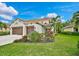 Two-story house with a three-car garage and manicured lawn at 12232 Stuart Dr, Venice, FL 34293