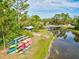 Community kayak and paddleboard storage with a nearby footbridge at 12232 Stuart Dr, Venice, FL 34293