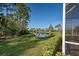 Backyard view with pond and lush landscaping at 1586 Monarch Dr # 1586, Venice, FL 34293
