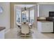 Cozy breakfast nook with a round table and four chairs, near kitchen at 1586 Monarch Dr # 1586, Venice, FL 34293