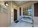 Front porch with bench and entryway into home at 1586 Monarch Dr # 1586, Venice, FL 34293