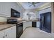Modern kitchen with white cabinets, black appliances, and granite countertops at 1586 Monarch Dr # 1586, Venice, FL 34293