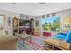 Bright living room with colorful rug and large window at 270 Capri Ave, Venice, FL 34293