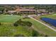 Aerial view of a country club with golf course, clubhouse, and lush landscaping at 277 Mestre Pl, North Venice, FL 34275
