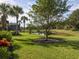 Landscaped backyard with pond views and lush green grass at 277 Mestre Pl, North Venice, FL 34275