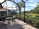 Spacious screened patio overlooking a pond and lush landscape at 277 Mestre Pl, North Venice, FL 34275