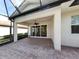 Covered patio with pavers and sliding glass doors leading inside at 277 Mestre Pl, North Venice, FL 34275