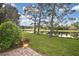 Serene backyard with pond views and lush greenery at 857 Tartan Dr, Venice, FL 34293