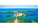 Aerial view of waterfront property with a bridge and lush landscape at 5 N Casey Key Rd, Osprey, FL 34229