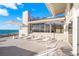 Beachfront patio with lounge chairs and ocean view at 5 N Casey Key Rd, Osprey, FL 34229