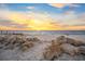 Beachfront with rocks and a beautiful sunset at 5 N Casey Key Rd, Osprey, FL 34229