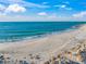 Expansive sandy beach with gentle waves and a rocky shoreline at 5 N Casey Key Rd, Osprey, FL 34229