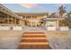 Wooden steps leading to a beach house with expansive windows and ocean view at 5 N Casey Key Rd, Osprey, FL 34229