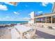 Beachfront patio features white furniture and ocean views at 5 N Casey Key Rd, Osprey, FL 34229