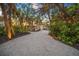 Long driveway leading to a charming beach house at sunset at 5 N Casey Key Rd, Osprey, FL 34229